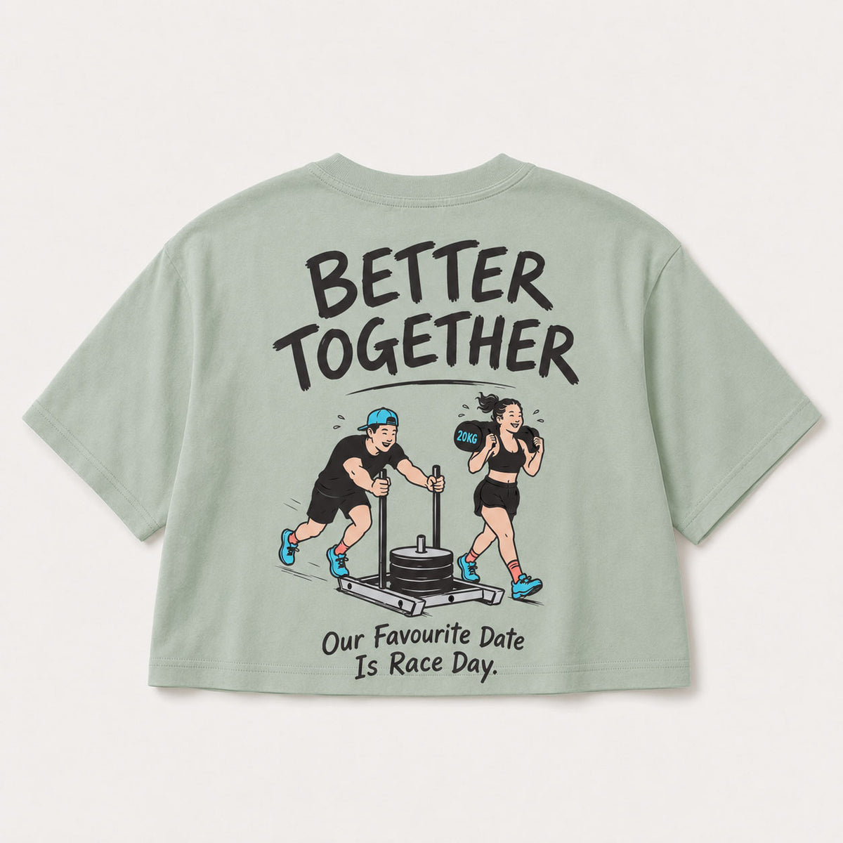 A sage green short-sleeve t-shirt shown from the back, featuring a cartoon graphic of a man pushing a weight stack and a woman boxing, with the text 'BETTER TOGETHER' and 'Our Favourite Date Is Race Day.'.